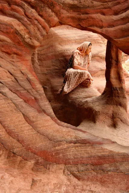 Runner-up. “This was taken one morning just after sunrise in Petra. I was on a guided walk through the city. Having just seen the spectacular Treasury, I walked past these cave-like structures and spotted a lady posing for a photo for her husband”. PAUL GOLDSTEIN, JUDGE: “This makes me look twice. The colouring is clearly not by coincidence and it is provocative and thoughtful. However, with such captivating patterns in the sandstone I would have liked her smaller and more pattern to be shown. It is well conceived but could have been even better; top work though”. (Photo by Roslin Zuha/The Guardian)