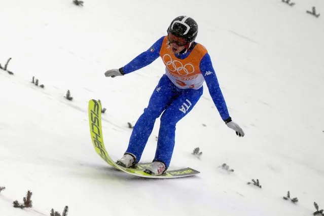 Iacopo Bortolas, of Italy, lands during the team Gundersen large hill/4x5km ski jumping trial round at the 2022 Winter Olympics, Thursday, February 17, 2022, in Zhangjiakou, China. (Photo by Matthias Schrader/AP Photo)