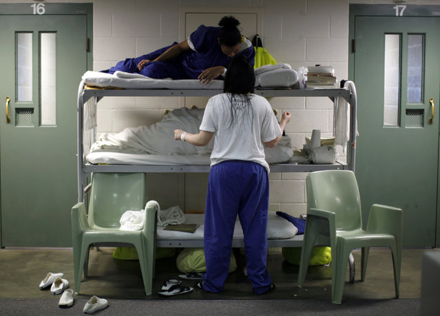 Women chat as they lie in beds placed in the communal area outside cells, due to overcrowding at the Los Angeles County Women's jail in Lynwood, California April 26, 2013. (Photo by Lucy Nicholson/Reuters)