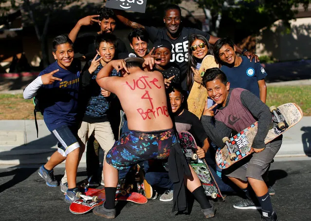 Isaiah Erich of San Diego, 14, shows off his back as he skateboards with friends outside a rally for U.S. Democratic presidential candidate Bernie Sanders in National City, California, United States May 21, 2016. (Photo by Mike Blake/Reuters)