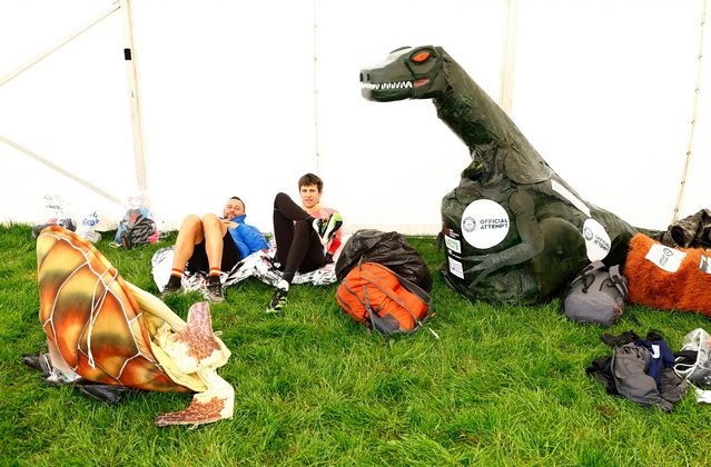 Runners wait alongside their fancy dress costumes before the start of the London Marathon in London, United Kingdom on April 23, 2023. (Photo by Peter Cziborra/Reuters)