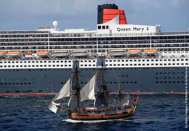 The Queen Mary 2 is saluted by the HMB Endeavour, the replica of Captain James Cook's ship off the coast of Victoria, Australia
