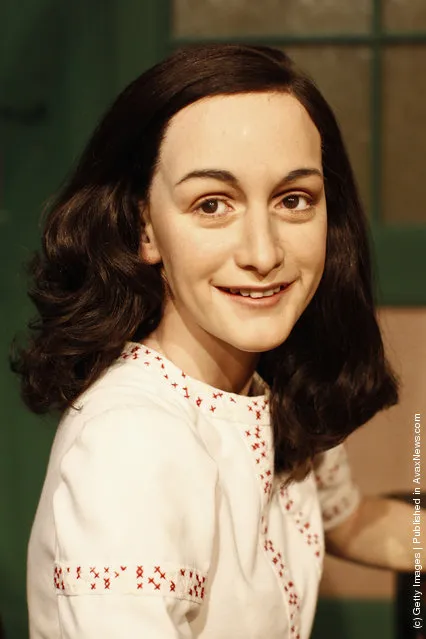A wax figure of Anne Frank and their hideout reconstruction is unveiled at Madame Tussauds in Berlin