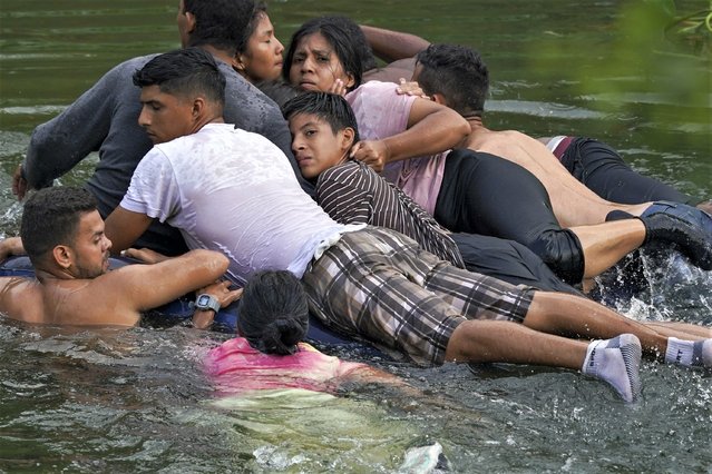 Migrants cross the Rio Bravo on an inflatable mattress into the United States from Matamoros, Mexico, Tuesday, May 9, 2023. The U.S. is preparing for the Thursday, May 11th end of the Title 42 policy, linked to the coronavirus pandemic that allowed it to quickly expel many migrants seeking asylum. (Photo by Fernando Llano/AP Photo)