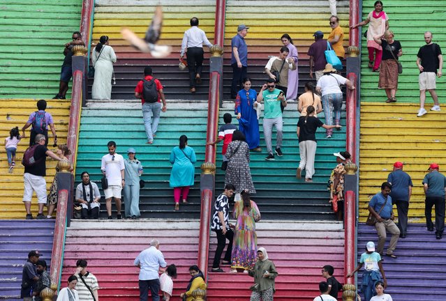 Tourists and Hindu devotees are seen on the 272 steps of Sri Subramaniar Swamy Temple at Batu Caves, Malaysia on April 19, 2024. (Photo by Hasnoor Hussain/Reuters)