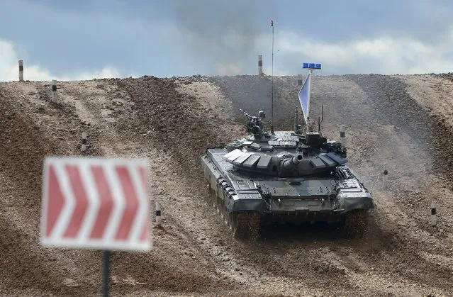 A tank drives on the course of the Tank Biathlon competition during an opening ceremony of the International Army Games-2015 in Alabino, outside Moscow, Russia, August 1, 2015. (Photo by Maxim Shemetov/Reuters)