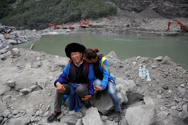 Relatives of victims react at the site of a landslide in the village of Xinmo, Mao County, Sichuan Province, China June 26, 2017. (Photo by Aly Song/Reuters)