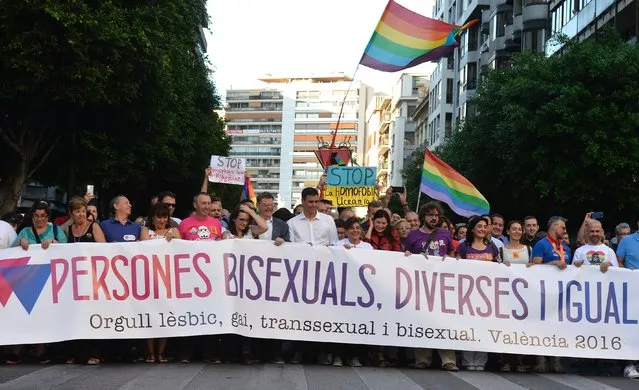 Spanish Socialist Party (PSOE) leader and candidate for the June 26 general elections Pedro Sanchez (C), Valencian President Ximo Puig (CL) and leader of Compromis party Monica Oltra (C2ndL) walk behind a banner during the Gay pride of Valencia, on June 18, 2016. (Photo by Jose Jordan/AFP Photo)