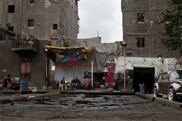 In this Tuesday, February 14, 2017 photo, boys rest at a car wash in the Sayeda Zeinab neighborhood of Cairo, Egypt. (Photo by Nariman El-Mofty/AP Photo)