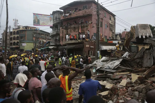 Rescue workers search for survivors at the rubbles of a collapsed building in a densely populated neighborhood in Lagos, Nigeria. Tuesday, July 25, 2017. Rescue work is still ongoing. (Photo by Sunday Alamba/AP Photo)
