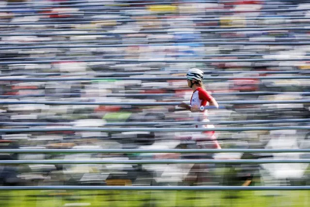An athlete runs in the transition zone during the Ironman 70.3 triathlon in Rapperswil, Switzerland, 19 June 2022. (Photo by Michael Buholzer/EPA/EFE)