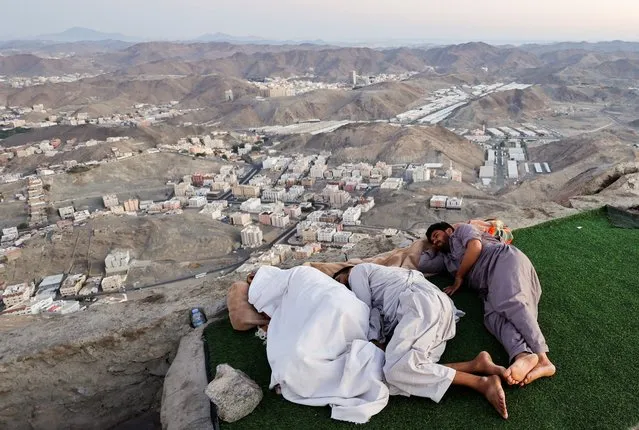 Muslim pilgrims visit Mount Al-Noor, where Muslims believe Prophet Mohammad received the first words of the Koran through Gabriel in the Hira cave, in the holy city of Mecca, Saudi Arabia on July 4, 2022. (Photo by Mohammed Salem/Reuters)