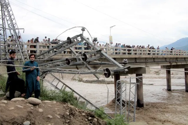 Damaged electrical towers on the ground after being damaged during the floods in Mingora, the capital of Swat valley in Pakistan, Saturday, August 27, 2022. Officials say flash floods triggered by heavy monsoon rains across much of Pakistan have killed nearly 1,000 people and displaced thousands more since mid-June. (Photo by Naveed Ali/AP Photo)