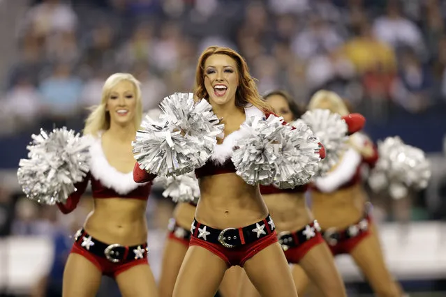 Members of the Dallas Cowboys cheerleaders perform at halftime of an NFL football game against the Green Bay Packers, Sunday, December 15, 2013, in Arlington, Texas. (Photo by Tim Sharp/AP Photo)