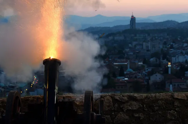 Fireworks mortar is fired, from a hill overlooking old town, Sarajevo, on April 23, 2020, during the national lockdown aimed at curbing the spread of the COVID-19 disease, caused by the novel coronavirus. Mortar was fired to mark begining of the holy Muslim month of Ramadan, during which Muslims around the world, fast from sunrise till sunset. Percussion round is fired in sunset, every day during the Islamic holly month of Ramadan, marks the end of daily fasting. (Photo by Elvis Barukcic/AFP Photo)