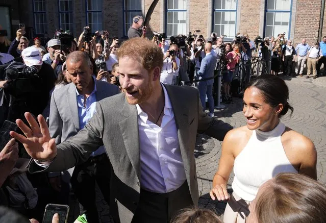 Britain's Prince Harry, left, and Meghan, Duchess of Sussex, meet people after a visit at the town hall in Duesseldorf, Germany, Tuesday, September 6, 2022. Prince Harry visits the city as ambassador for the Invictus games, a week-long games for active servicemen and veterans who are ill, injured or wounded, hosted by Duesseldorf next year. (Photo by Martin Meissner/AP Photo)