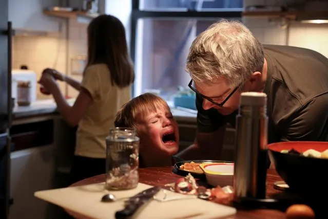 Felix Hassebroek is comforted by his father after dropping food at lunch during the outbreak of the coronavirus disease (COVID-19) in Brooklyn, New York City, New York, U.S., April 24, 2020. (Photo by Caitlin Ochs/Reuters)