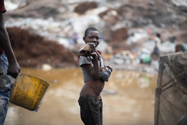 Abdou Fatao Pafadenam, 11, wraps stone blocks in his t-shirt in Pissy informal granite quarry since schools closed, amid the outbreak of the coronavirus disease (COVID-19), in Ouagadougou, Burkina Faso June 12, 2020. Youth can legally work at the site at age 16. But despite the law, some 42% of Burkinabe children between the ages of 5 and 14 engage in some form of labor including back-breaking work in quarries, gold mines and cotton fields, according to a 2018 report by the U.S. Bureau of International Labor Affairs. (Photo by Anne Mimault/Reuters)