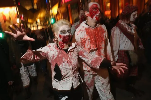 Zombie enthusiasts set out on a “Zombie Walk” in the city center on October 27, 2012 in Berlin, Germany. Approximately 150 zombies, who had organized themselves through Facebook, walked and limped across Alexanderplatz, growled and moaned at passersby and performed jerking dances. (Photo by Sean Gallup)