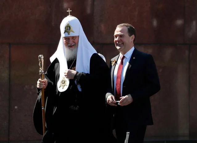 Deputy Head of Russia's Security Council Dmitry Medvedev and Patriarch Kirill of Moscow and All Russia attend the Victory Day Parade in Red Square in Moscow, Russia, June 24, 2020. The military parade, marking the 75th anniversary of the victory over Nazi Germany in World War Two, was scheduled for May 9 but postponed due to the outbreak of the coronavirus disease (COVID-19). (Photo by Dmitry Astakhov/Sputnik/Pool via Reuters)