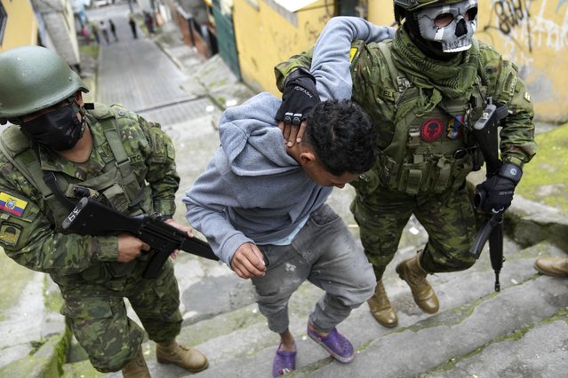Soldiers briefly detain a youth to walk him to an area to check if he has gang-related tattoos as they patrol the south side of Quito, Ecuador, Friday, January 12, 2024, in the wake of the apparent escape of a powerful gang leader from prison. President Daniel Noboa decreed Monday a national state of emergency, a measure that lets authorities suspend people's rights and mobilize the military. (Photo by Dolores Ochoa/AP Photo)