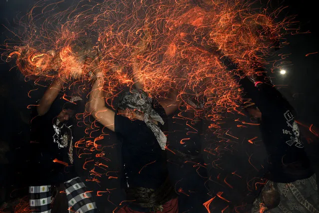 Participants fight during fire war ceremony at Dalem Temple on October 8, 2014 in Tuban, Kuta, Indonesia. (Photo by Putu Sayoga/Getty Images)