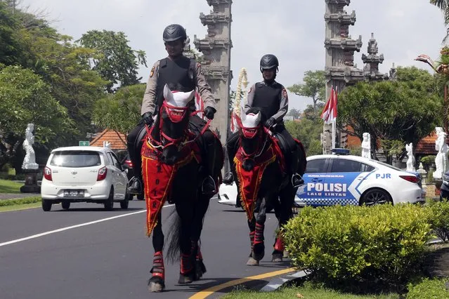 Mounted police patrol a street ahead of the G20 Summit in Nusa Dua, Bali, Indonesia, Sunday, November 13, 2022. Indonesia is gearing up to host the gathering of the leaders of the world's biggest economies this week. (Photo by Firdia Lisnawati/AP Photo)