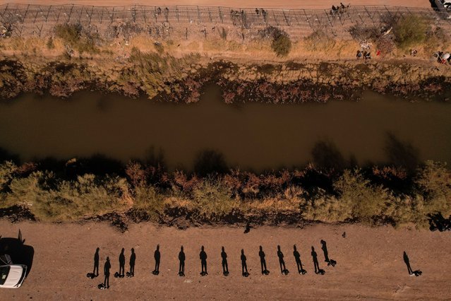 A drone view of members of the Mexican National Guard in riot gear, standing guard near the Rio Bravo river, after rumours spread that migrants would be allowed to enter the United States, according to local media, in Ciudad Juarez, Mexico on December 18, 2024. (Photo by Jose Luis Gonzalez/Reuters)