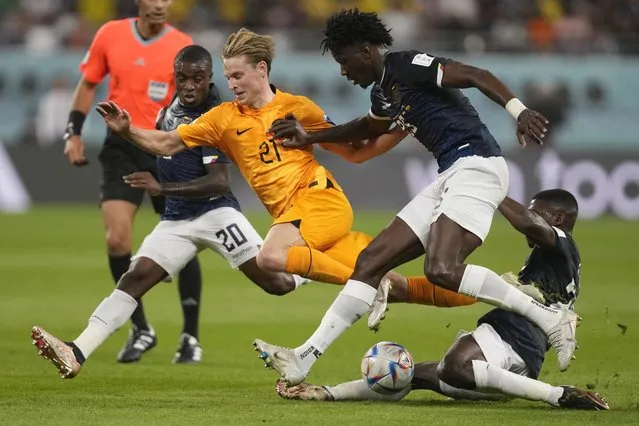 Frankie de Jong of the Netherlands, centre, challenges for the ball with Ecuador's Jhegson Mendez, left, Jackson Porozo and Moises Caicedo, right, during the World Cup group A soccer match between the Netherlands and Ecuador at the Khalifa International Stadium in Doha, Qatar, Friday, November 25, 2022. (Photo by Darko Vojinovic/AP Photo)