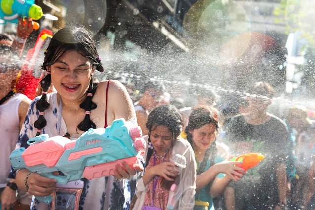 Revellers play with water as they celebrate the Songkran holiday, which marks the Thai New Year, in Bangkok, Thailand, on April 13, 2025. (Photo by Chalinee Thirasupa/Reuters)