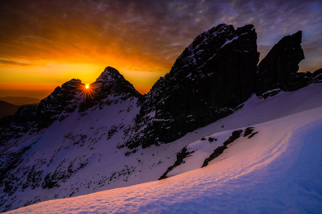 The sun rises between Sgurr nan Gillean and Knight’s Peak, Black Cuillin, Isle of Skye. (Photo by Adrian Trendall/Mountain Photo of the Year)