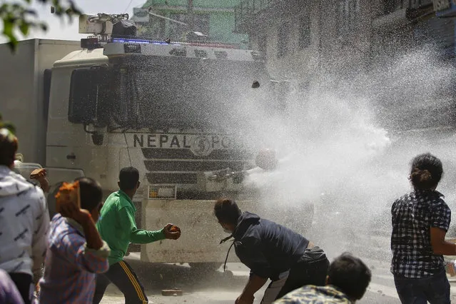 Local people attack a police water cannon truck during a clash between the devotees and police in Lalitpur, Nepal, on September 3, 2020. Nepalese police interrupted the chariot festival of Rato Machhindranath amid the ban on public and religious gatherings to control the spread of COVID-19. (Photo by Chine Nouvelle/SIPA Press/Rex Features/Shutterstock)