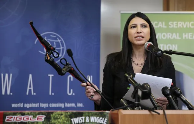 Joan Siff, president of World Against Toys Causing Harm Inc., holds up toy bow at Children's Franciscan Hospital in Boston, Wednesday, November 19, 2014. (Photo by Charles Krupa/AP Photo)