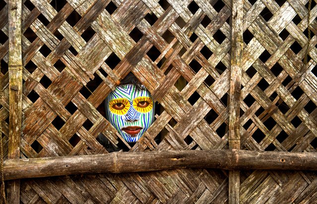 A child poses with face painting during the event in Canning, West Bengal on June 15, 2025. For generations Bahurupi artists from West Bengal have been practicing in the art of face painting. Using their painting techniques they can easily metamorphose into different characters during a performance, which often represents tribal myths. These traditional artists scrape a living from their performances, relying on the generosity of audiences for their income. (Photo by Avishek Das/SOPA Images/LightRocket via Getty Images)
