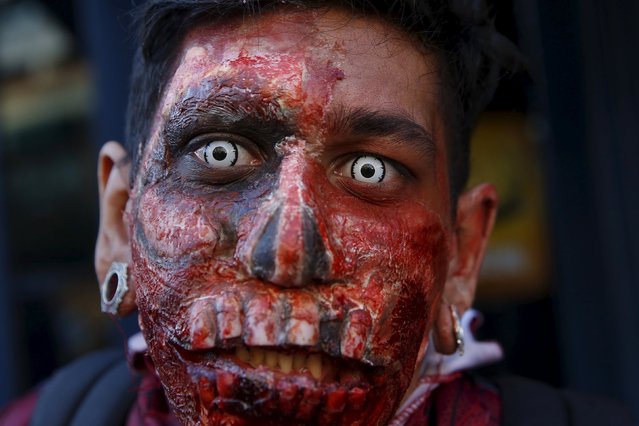 Arthur Padilla poses in costume during the NYC Zombie Crawl in New York, October 18, 2015. (Photo by Shannon Stapleton/Reuters)