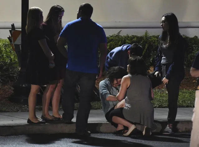 Parents meet at a hotel in Coral Springs, Fla., Wednesday, February 14, 2018, to pick up their children, following a shooting at nearby Marjory Stoneman Douglas High in Parkland, Fla. A former student opened fire at the Florida high school Wednesday, killing more than a dozen people and sending scores of students fleeing into the streets. (Photo by Jim Rassol/South Florida Sun-Sentinel via AP Photo)