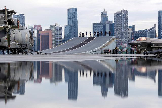 Ship's Company line up on the ramp for Procedure B, as Aircraft Carrier HMS Prince of Wales sails into Singapore on June 23, 2025. AS1 (Photo by Amber Mayall/MOD Crown Copyright 2025/Handout via Reuters)