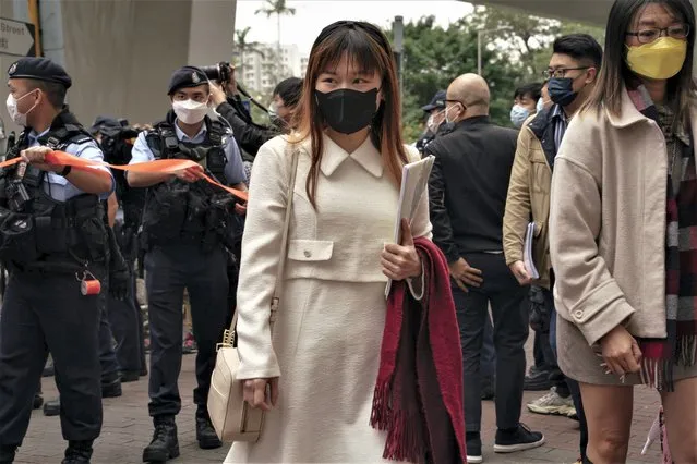 Pro-democracy activist Clarisse Yeung Suet-ying, center, arrives at the West Kowloon Magistrates' Courts to attend her national security trial in Hong Kong, Monday, February 6, 2023. Some of Hong Kong's best-known pro-democracy activists went on trial Monday in the biggest prosecution yet under a law imposed by China's ruling Communist Party to crush dissent. (Photo by Anthony Kwan/AP Photo)