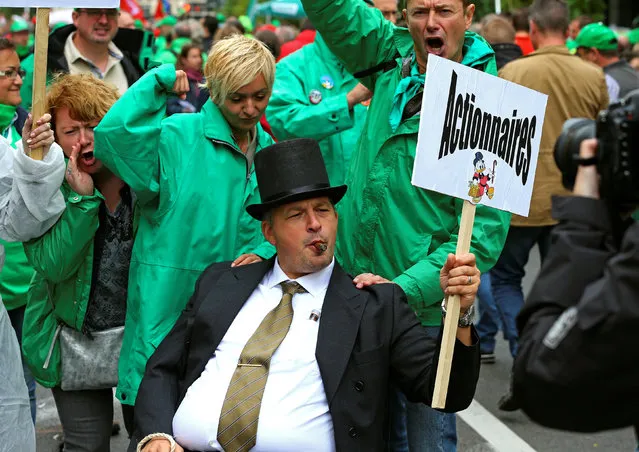 Trade union members march downtown during a protest over the government's reforms and cost-cutting measures in Brussels, Belgium September 29, 2016. The placard reads “shareholders”. (Photo by Yves Herman/Reuters)