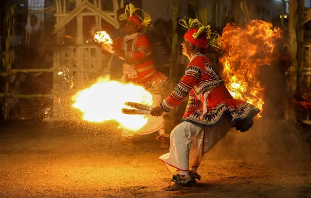 Sri Lankan traditional dancers perform with fire during the traditional ritual Gammaduwa ceremony in the Pannipitiya suburb of Colombo, Sri Lanka, 13 September 2020. The traditional Gammaduwa, or village hut ceremony, is one of the most important rituals performed in the lowland areas of Sri Lanka. It is performed by Sinhala Buddhists for the prevention of diseases and for increased fertility. The ritual, which has South Indian origins, is performed throughout a night on behalf of the goddess Pattini. (Photo by Chamila Karunarathne/EPA/EFE/Rex Features/Shutterstock)