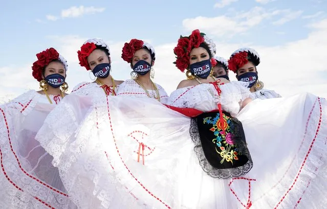 Dancers from a local Mexican dance company wear Biden/Harris face masks during a drive-in campaign event for Democratic U.S. presidential nominee Joe Biden at the Southeast Career Technical Academy in Las Vegas, Nevada, U.S., October 9, 2020. (Photo by Kevin Lamarque/Reuters)