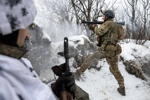 Bohdan, “Fritz”, the deputy of commander of the unit in 79th Air Assault Brigade, fires a rocket-propelled grenade (RPG) towards Russian positions on a frontline near the town of Marinka, amid Russia's attack on Ukraine, Donetsk region, Ukraine on February 14, 2023. (Photo by Marko Djurica/Reuters)