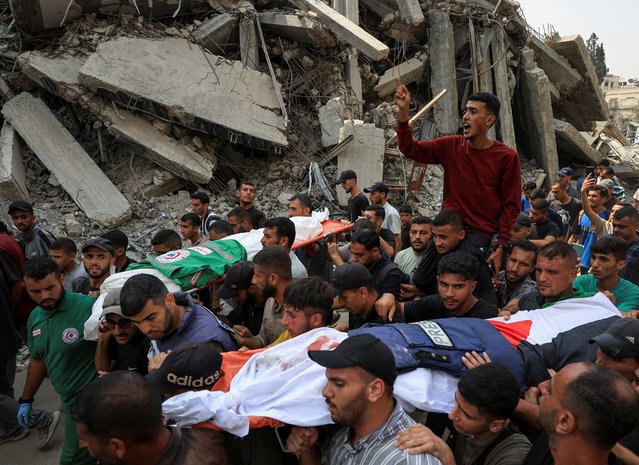 A flak jacket and a Palestinian flag are placed on the body of Al Jazeera journalist Anas Al Sharif, during the funeral for him, Mohammed Qreiqeh, Ibrahim Zaher, Mohammed Noufal and another colleague, who were killed in an Israeli strike, in Gaza City on August 11, 2025. (Photo by Dawoud Abu Alkas/Reuters)