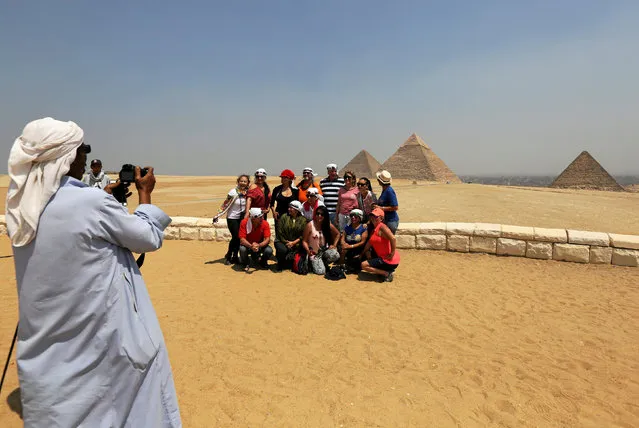 Tourists take a souvenir photo in front of the Great Giza pyramids on the outskirts of Cairo, Egypt, August 31, 2016. (Photo by Mohamed Abd El Ghany/Reuters)