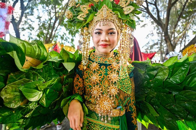 A participant takes part in a cultural carnival during celebrations marking Indonesia's 80th Independence day in Banda Aceh on August 18, 2025. (Photo by Chaideer Mahyuddin/AFP Photo)