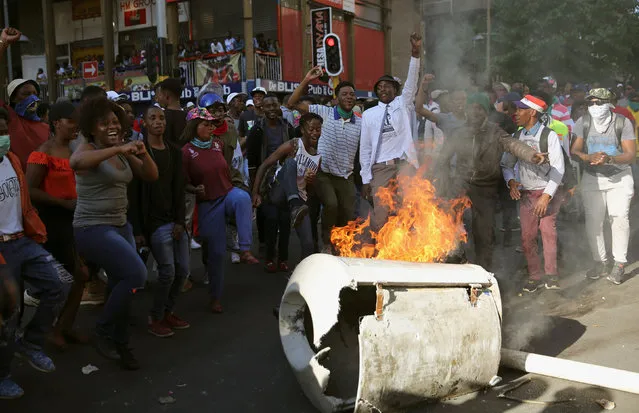 Students demanding free education chant slogans in front of burning barricade outside the University of the Witwatersrand at Braamfontein, in Johannesburg, South Africa, October 10, 2016. (Photo by Siphiwe Sibeko/Reuters)