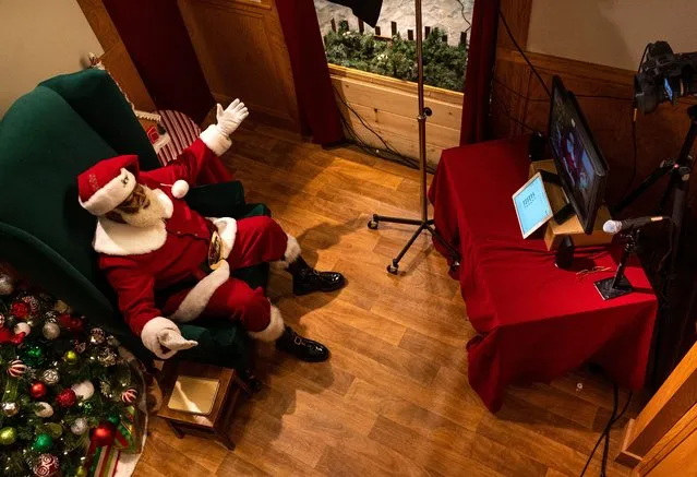 Santa Larry speaks with a virtual visitor at the Santa Experience in the Mall of America on November 24, 2020 in Bloomington, Minnesota. The owners had initially set up a socially distanced set, featuring a cabin with a plexiglass window, but moved completely online after new COVID-19 restrictions were put in place after last week's executive order from Minnesota Gov. Tim Walz. (Photo by Stephen Maturen/Getty Images)