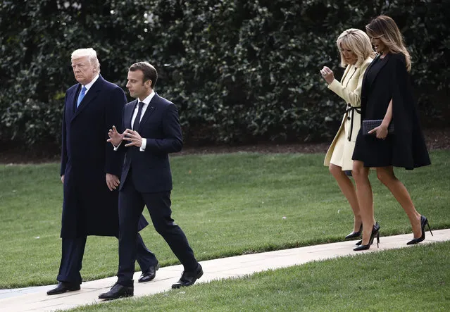 U.S. President Donald Trump and French President Emmanuel Macron walks together with their wives Brigitte Macron and first lady Melania Trump as they exit the West Wing to plant a tree together at the White House in Washington,  April 23, 2018. (Photo by Carlos Barria/Reuters)