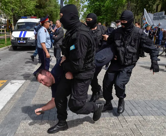 Policemen detain an opposition supporter during a protest rally in Almaty, Kazakhstan May 10, 2018. (Photo by Mariya Gordeyeva/Reuters)