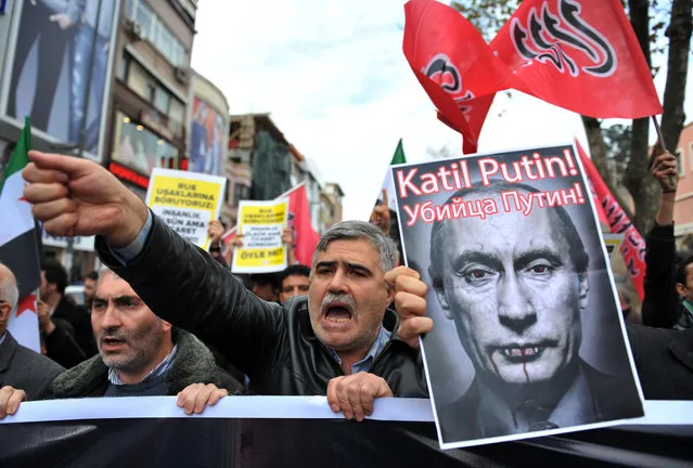 Turkish protesters shout anti-Russia slogans as they hold a poster of Russian President Vladimir Putin that reads in Turkish and Russian "Assassin Putin!" during a protest in Istanbul, Turkey, Friday, November 27, 2015. Turkey shot down a Russian Su-24 bomber at the Syrian border on Tuesday, insisting it had violated its airspace despite repeated warnings. (Photo by Omer Kuscu/AP Photo)